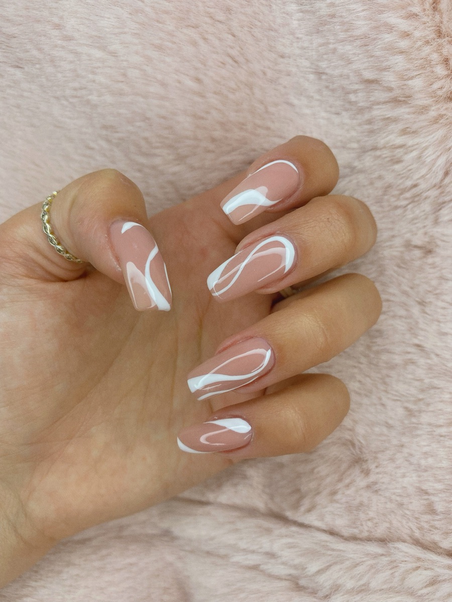 Nude nails with white swirl nail art